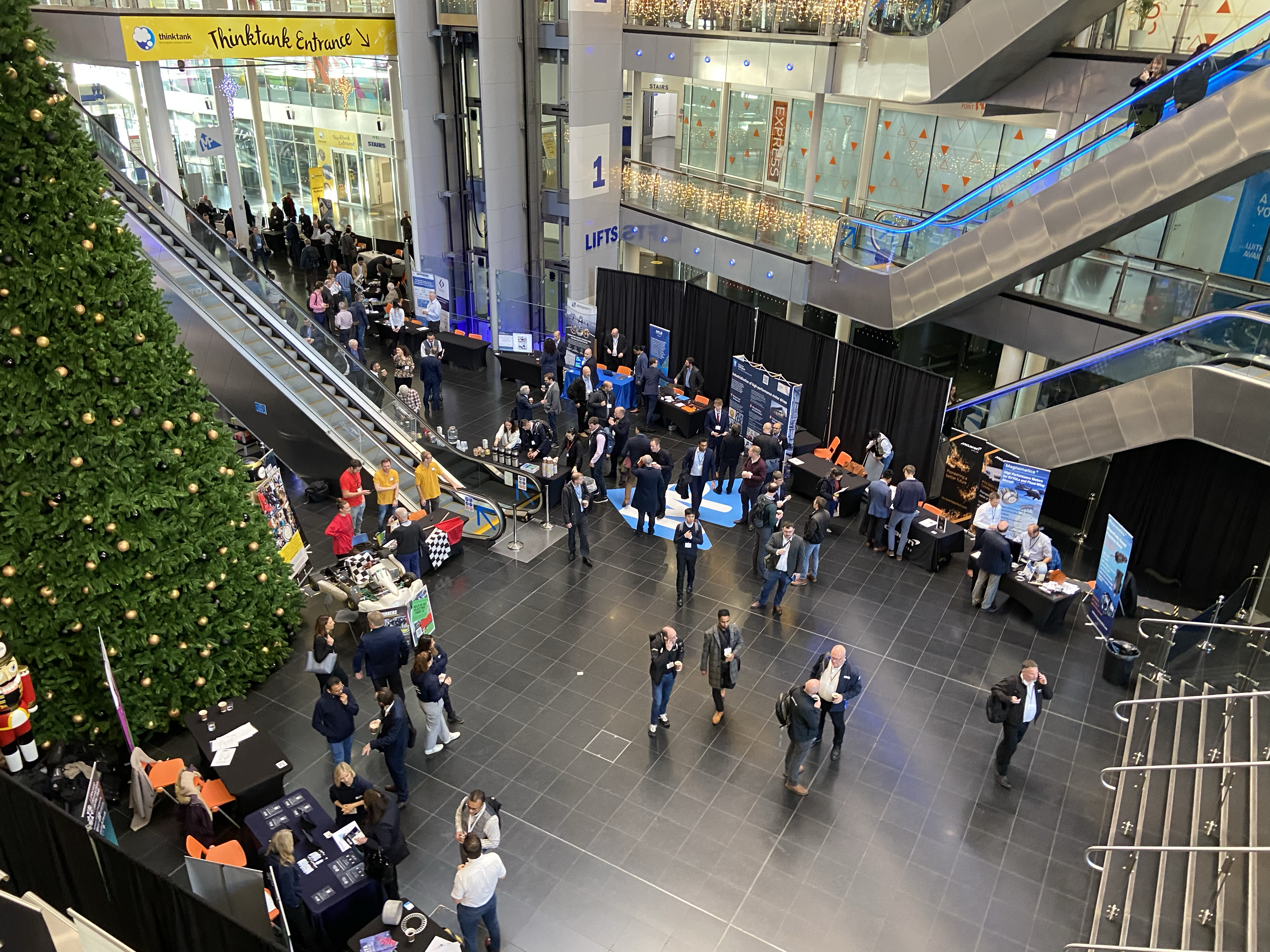 Overview of the atrium level exhibition stands at the event, featuring the fantastic networking and meaningful discussions taking place on the day, by 300 people throughout the day across the 40+ exhibition stands. 