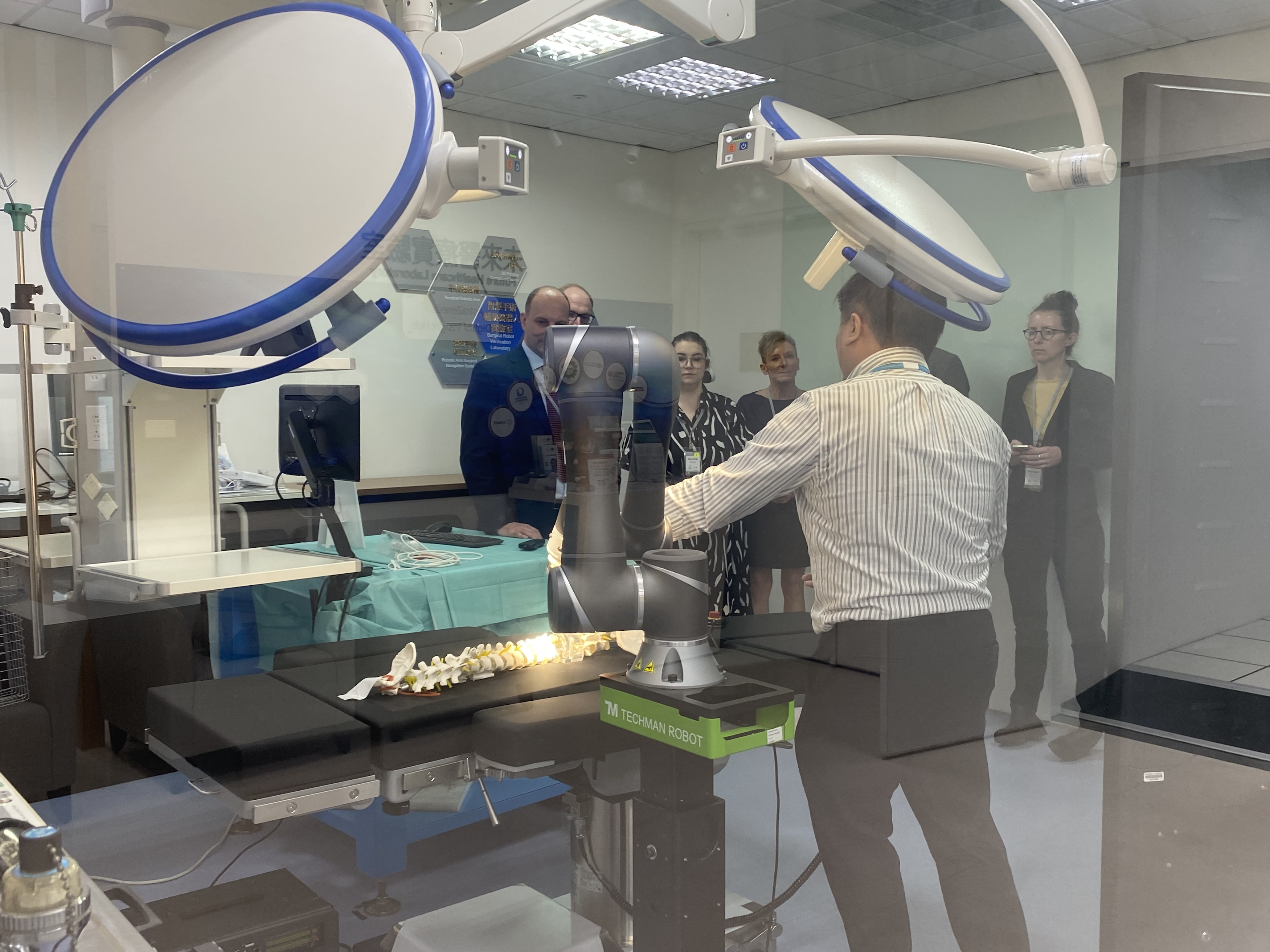 group crowded around a surgical robot